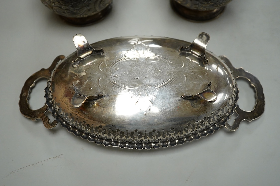 A pair of Edwardian repousse silver pedestal bowls, by Charles Boyton & Son Ltd, London, 1906, diameter 11.4cm(a.f.), 6.9oz and a plated two handled dish.